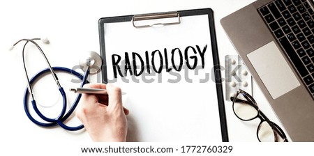 Doctor holding a card with text RADIOLOGY,medical concept