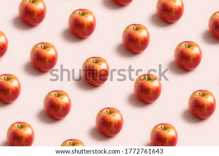 Apple minimal pattern at soft pink background. Concept of harvest raw food. Space for text, delicious sweet fruits