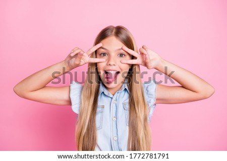 Close-up portrait of her she nice attractive pretty comic childish glad cheerful cheery preteen girl showing double v-sign tongue having fun fooling isolated over pink pastel color background