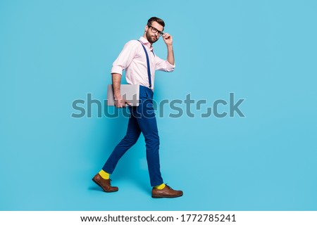 Full size profile photo of handsome confident guy carry notebook walk corporate meeting office successful worker wear specs shirt suspenders pants footwear isolated blue color background Royalty-Free Stock Photo #1772785241