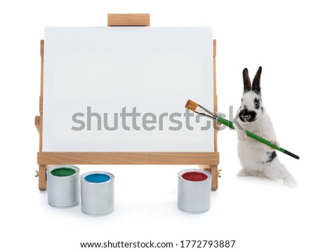  bunnies stand at the easel with tassels isolated on a white background. for writing your text