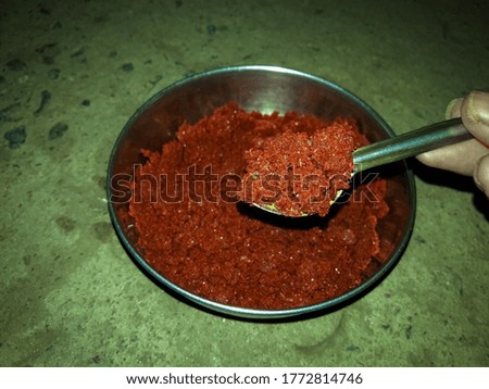 Spoon the ground red chili