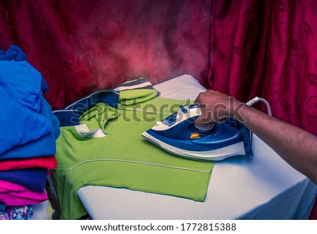 Close up of a man ironing the dress at home due to lockdown of laundry shops shops