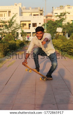 Brown Indian adult on Skateboard 