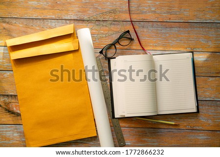 Photo of blank vintage stationery set on light wooden background. Top view. Flat lay