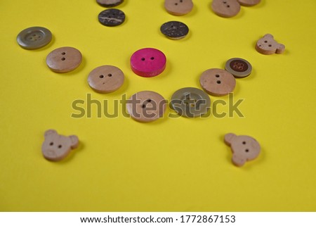 Many colorful garment buttons in various shapes and sizes on colorful background
