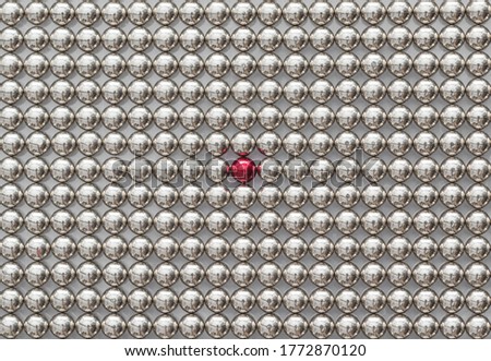 Full Frame of Metal Magnetic Balls for background. The Neocube Spheres with one red sphere. Stand out of the crowd