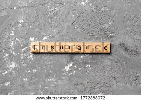 insurance word written on wood block. insurance text on table, concept.