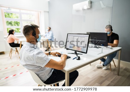 Call Center Customer Service Agents Wearing Face Masks Royalty-Free Stock Photo #1772909978