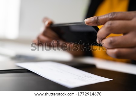 Remote Check Deposit Taking Photo With Mobile Phone Royalty-Free Stock Photo #1772914670