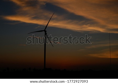 Windmill turbine and landscape during sunset in Indonesia. Wind turbine is renewable energy for better sustainability.