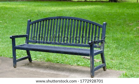 A close view of the black metal park bench in the park.