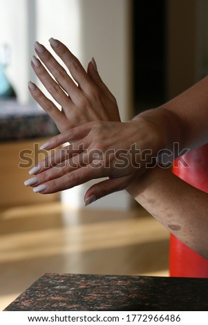 Female hand model with hands crossed.