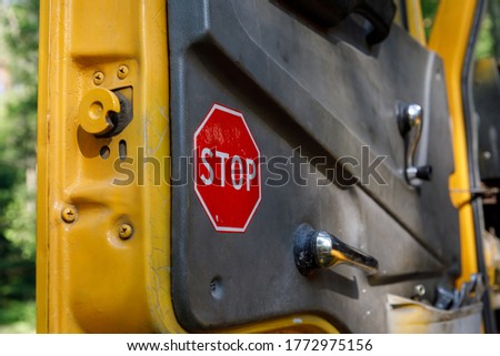 Stop sign on the car door. truck cab overlooking the steering wheel 