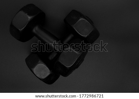 Dumbbells or weights for exercise on a black background