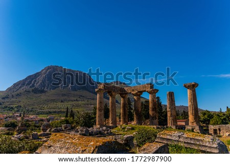 Archaeological Site Of Corinth And Temple of Apollo with Acrocorinth fortress for background. The Temple of Apollo in Ancient Corinth and the Acrocorinth fortress in Corinth, Greece Royalty-Free Stock Photo #1772987900