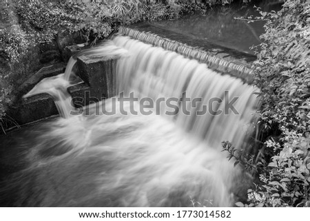 Long exposure of a waterfall on the River Lim in Lyme Regis in Dorset