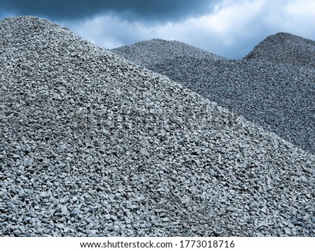 a mountain of granite rubble against a blue sky. building material