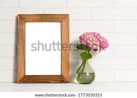 Empty wooden frame with pink hydrangea flowers
