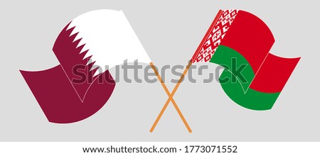 Crossed and waving flags of Belarus and Qatar
