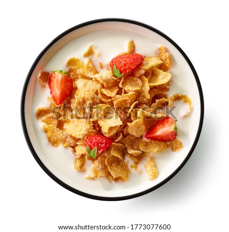bowl of cornflakes with milk and strawberry pieces isolated on white background, top view Royalty-Free Stock Photo #1773077600