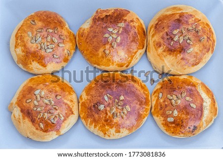 home made round pastry with olive paste and sunflower seeds