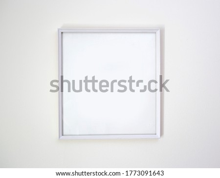 White photo frame on white wall, background, mock up
