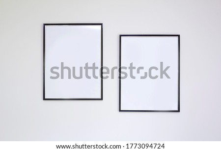 black photo frames on white wall, background, mock up
