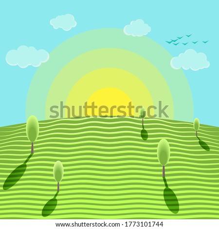 Sunrise against the blue sky and green meadow. Trees standing alone in a meadow and birds flying high in the sky