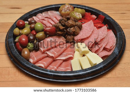 antipasto cheese and meats deli tray olives and stuffed peppers cater Royalty-Free Stock Photo #1773103586