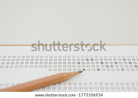 marked optical answer sheet with a pencil