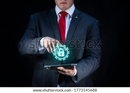 Elegant businessman and technology virtual projection of padlock and security icon on dark background.
