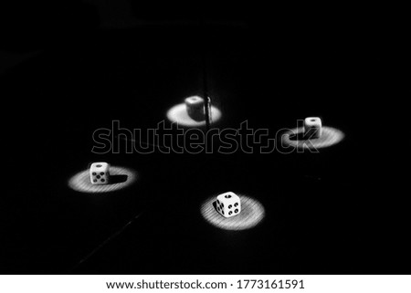 This is a picture of a black and white dice reflected in the mirror.
It's an abstract photograph.
The atmosphere is amazing.
It's an emotional picture.