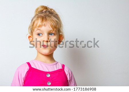 Portrait of funny and merry sweet little girl until she make funny face expression.