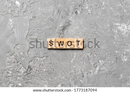 swot word written on wood block. swot text on table, concept.