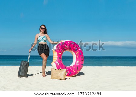 On the beach. Beautiful woman Hope for a beautiful future in retirement on a tropical beach with a fantastic seascape. Young tan model in stylish summer outfit, Concept freedom, journey, life, love.