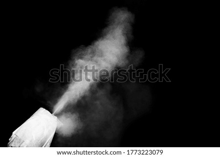 Abstract curly white steam, smoke flies out of the nozzle on a black background, copy space