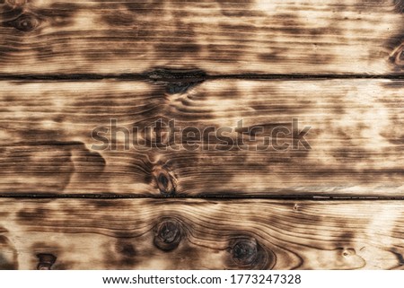 Brown wood background texture of processed wood. Background in the form of a wooden surface, lightly treated with light brown fire with texture stripes on the wood.