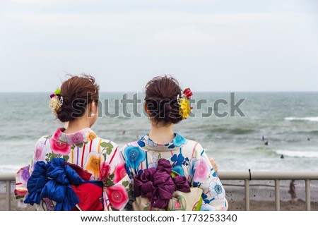 A woman wearing a yukata to stroll along the sea Royalty-Free Stock Photo #1773253340