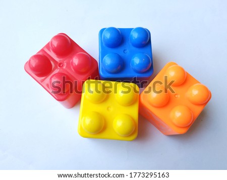 SOME MULTI COLOR CHILDREN PLAYING CUBES ISOLATED ON WHITE BACKGROUND