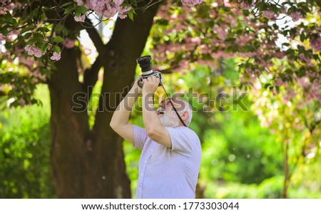 Express positivity. Cherry blossoming garden. photographer taking photos of famous cherry blossoms. spring season with full bloom pink flower. photographer man take sakura cheery blossom photo.