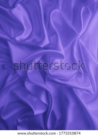Beautiful elegant wavy blue satin silk luxury cloth fabric texture, abstract background design.