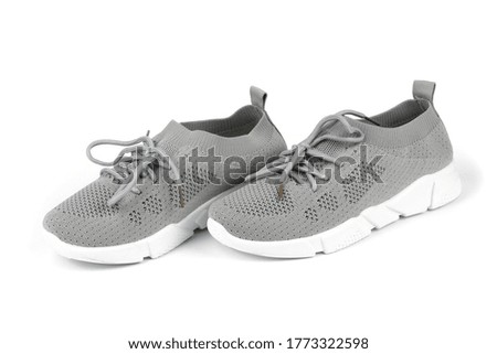 Pair of new grey sneakers isolated on white background. High resolution photo. Full depth of field.
