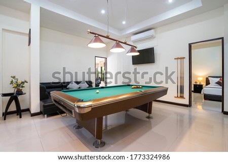 Interior design of modern house, home, villa feature pool table, shelve, sofa and television in living room Royalty-Free Stock Photo #1773324986