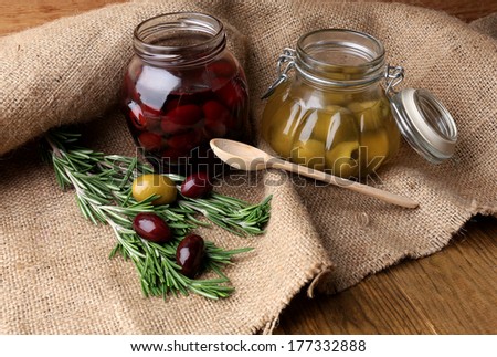 Tasty olives on wooden table