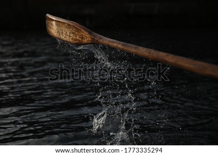 Fast Shutter speed photography of Water dripping from Paddle/Oar Coming out of Water while Rowing in late Sunnset