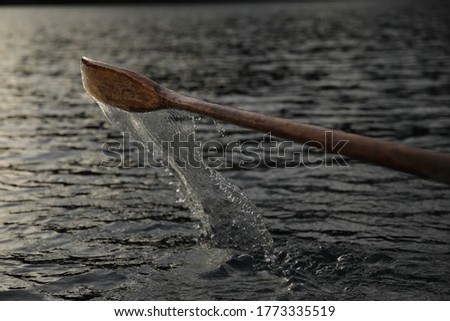 Fast Shutter speed photography of Water dripping from Paddle/Oar Coming out of Water while Rowing in late Sunnset
