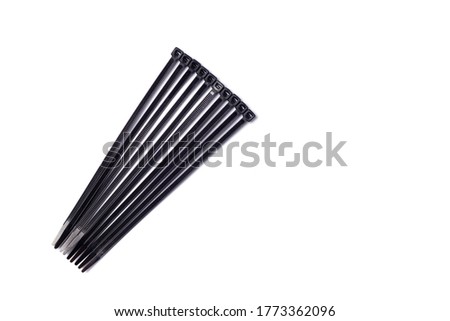 Black cable ties isolated on white background.