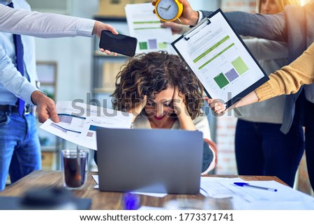 Group of business workers working together. Partners stressing one of them at the office Royalty-Free Stock Photo #1773371741