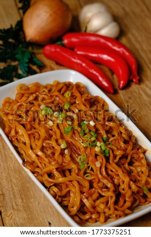 Ramyeon Ramen is a Korean fried spicy noodle or soup. Korean noodles are famous for their delicacy and spicy taste. Using spicy chili seasoning, chili sauce, shrimp, chicken, and sesame topping.